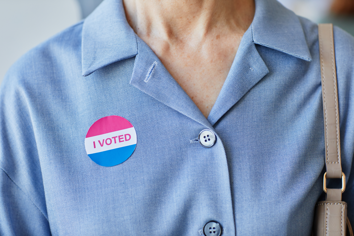 Person in blue top wearing an "I Voted" sticker