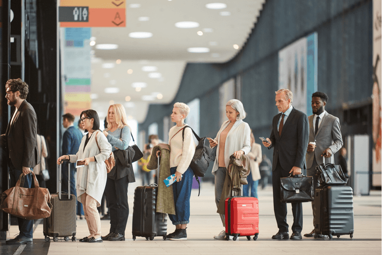 Group of people in line in the airport with their luggage