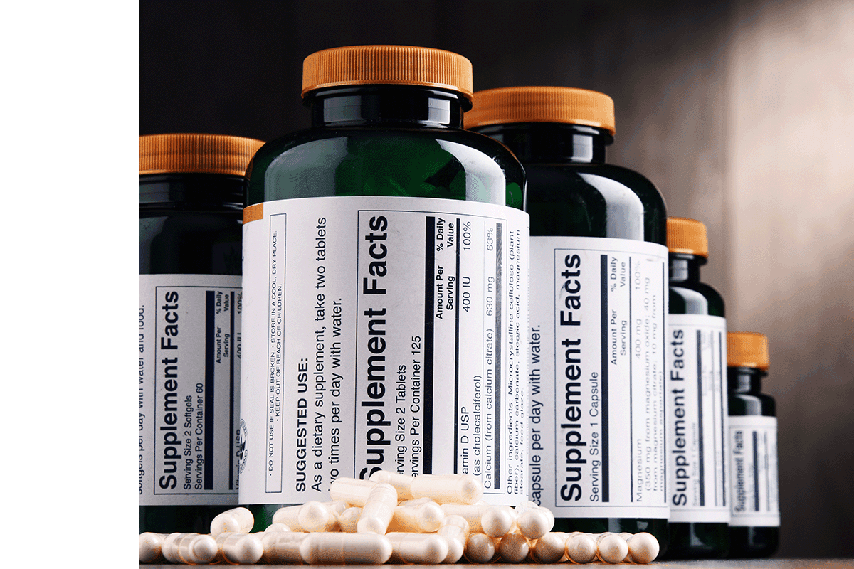 Supplement bottles lined up with supplements in front - header image