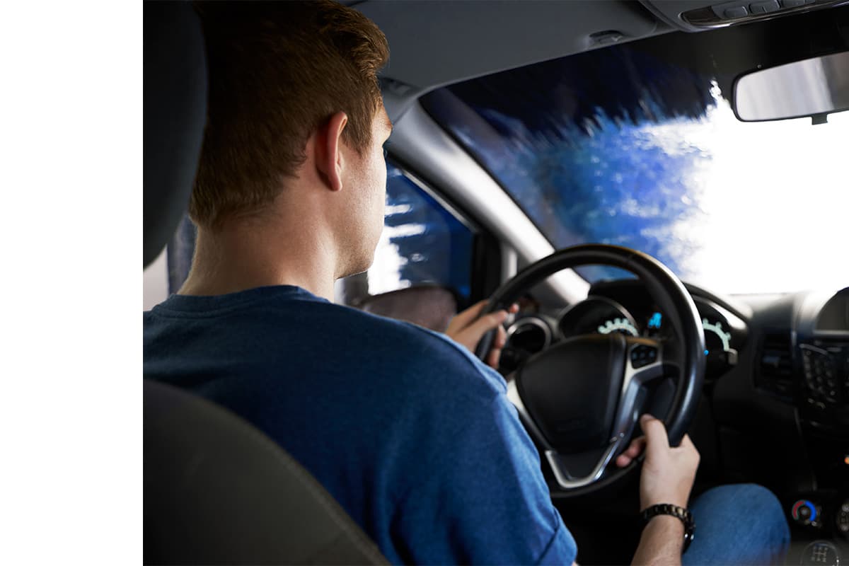 Man in the car getting his car washed