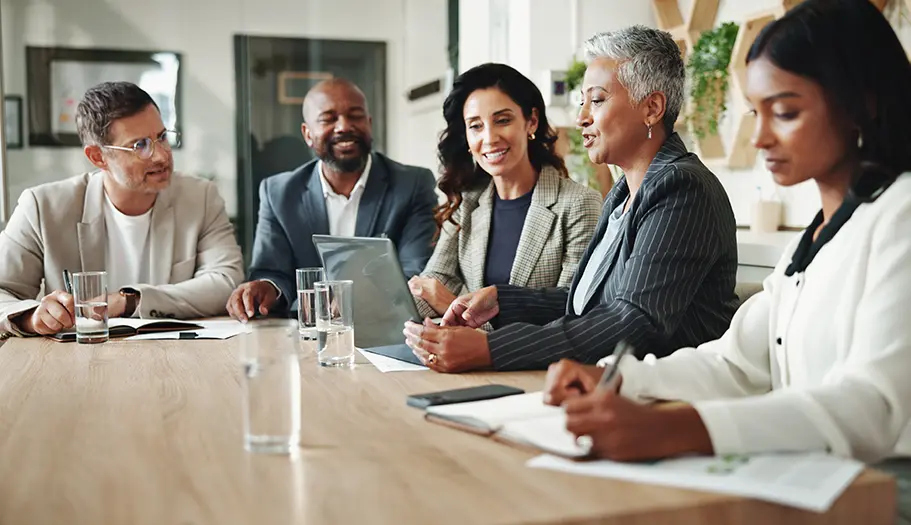 Corporate marketing team reviewing brand-approved advertising campaigns in a meeting