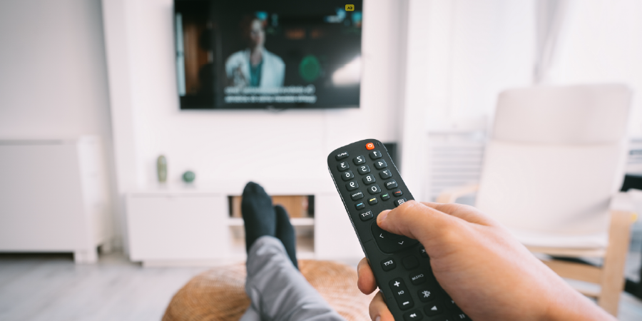 A TV remote control pointed at a TV screen