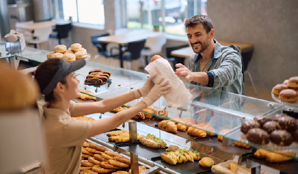 Man ordering a breakfast pastry at the local bakery