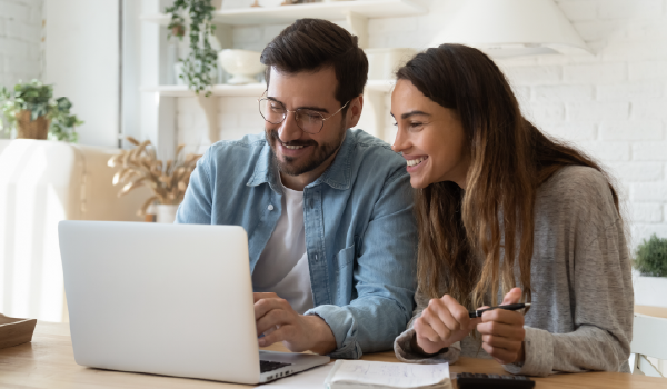 Two people looking at a laptop screen