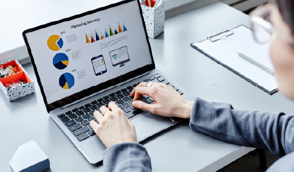 A laptop screen showing charts and graphs