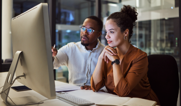 Two people looking at a computer screen