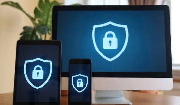 A computer screen, mobile screen, and tablet screen with a lock on them