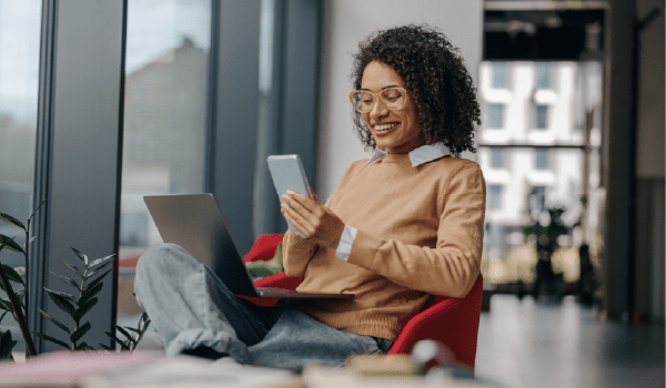 Woman using a tablet at home, illustrating how mobile ads support multi-location digital marketing campaigns.