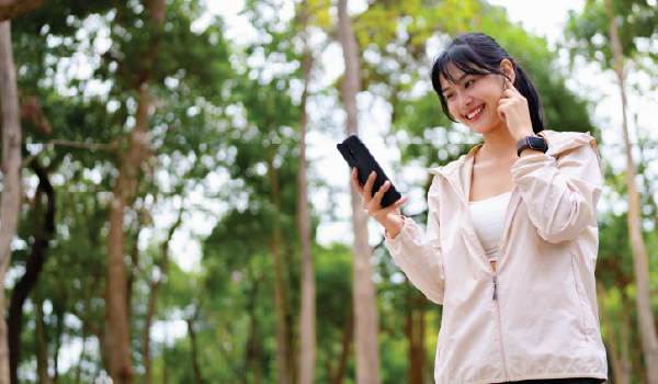 Woman walking in a park on her phone